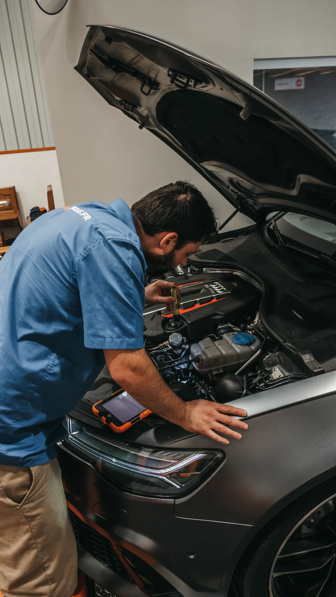 Mechanic examining a vehicle engine
