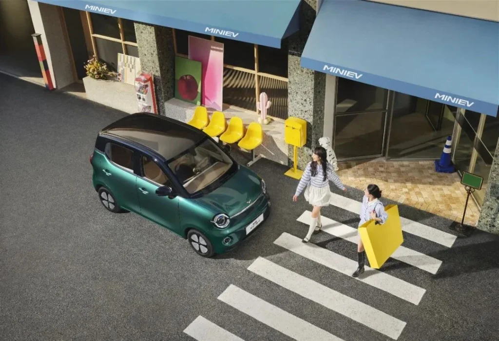 Fifth-generation Wuling Hongguang MINIEV in green from an elevated street angle