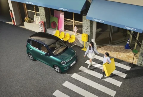 Fifth-generation Wuling Hongguang MINIEV in green from an elevated street angle